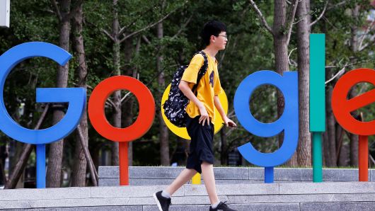 A man walks past the brand logo of Alphabet Inc's Google outside its office in Beijing, China, August 8, 2018. 