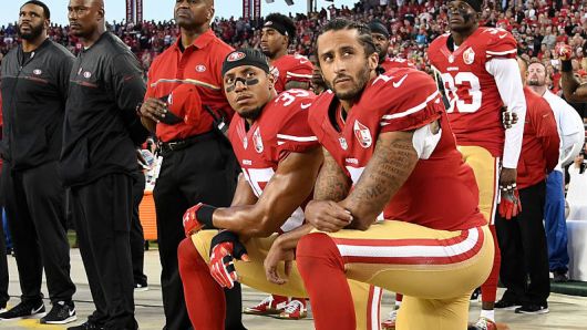 Colin Kaepernick #7 and Eric Reid #35 of the San Francisco 49ers kneel in protest during the national anthem prior to playing the Los Angeles Rams in their NFL game at Levi's Stadium on September 12, 2016 in Santa Clara, California.