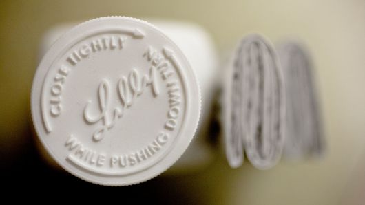 An Eli Lilly & Co. logo is seen on the cap of a pill bottle in this arranged photograph at a pharmacy in Princeton, Illinois.