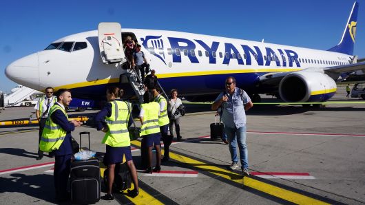 A Ryanair cabin crew awaits as passengers disembark on the tarmac at Brussels South Charleroi Airport in Charleroi on September 27, 2018.