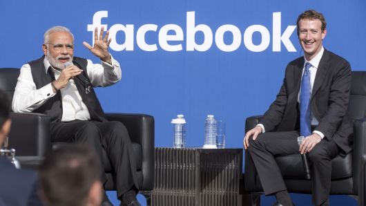 Narendra Modi, India's prime minister, speaks as Mark Zuckerberg, chief executive officer of Facebook, listens during a town hall meeting at Facebook headquarters in Menlo Park, California.