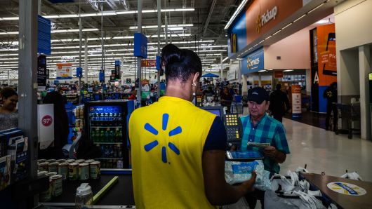 An employee scans a customer's purchases at a Walmart Inc. store in Secaucus, New Jersey, U.S., on Wednesday, May 16, 2018.