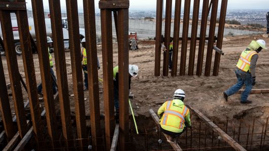 A construction crew works on replacing the US-Mexico border fence as seen from Tijuana, in Baja California state, Mexico, on January 9, 2019.