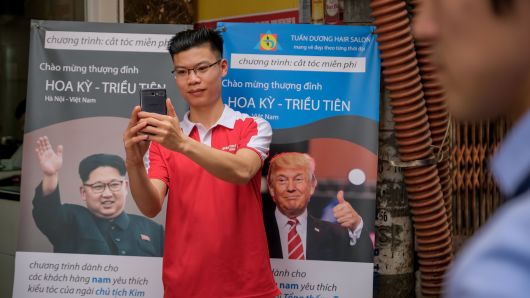 Le Van Nguyen, 27, takes selfies with U.S. President Donald Trump and North Korean leader Kim Jong-un posters after getting his free haircut in Kim-inspired style at Tuan Duong Beauty Academy on February 20, 2019 in Hanoi, Vietnam.
