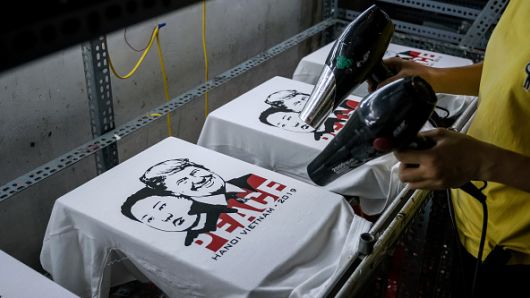 A worker at the t-shirt store of Truong Thanh Duc dry the newly printed t-shirts with the portraits of U.S. President Donald Trump and North Korean leader Kim Jong Un on February 21, 2019 in Hanoi, Vietnam.