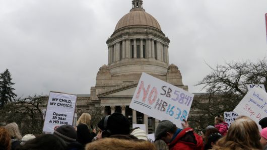 Opponents to efforts to remove philosophical exemptions from school-vaccine requirements rally outside the Washington Capitol, in Olympia, Wash., Wednesday, Feb. 20,2019.