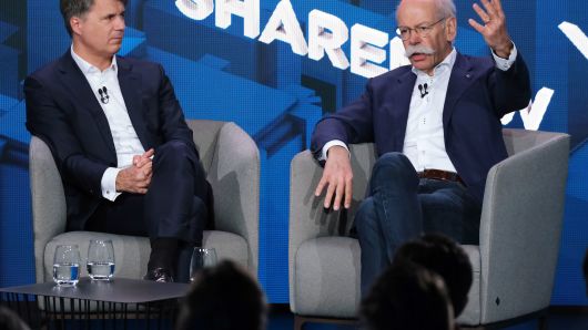 Harald Krüger (L), CEO of BMW AG, and Dieter Zetsche, CEO of Daimler AG, speak to the media about a new joint effort between the two automakers in carsharing on February 22, 2019 in Berlin, Germany.