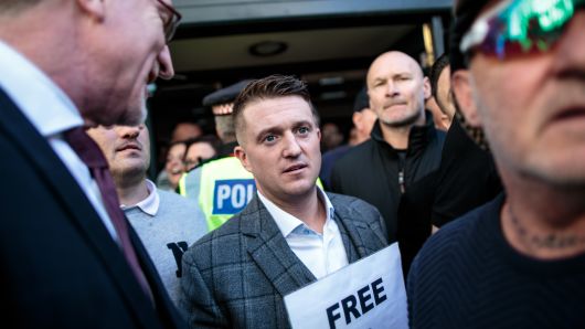 Far-right figurehead Tommy Robinson, real name Stephen Yaxley-Lennon, greets supporters outside the Old Bailey after his case was adjourned on September 27, 2018 in London, England.