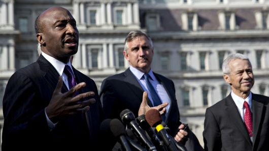 Ken Frazier, chairman and chief executive officer of Merck & Co., left, speaks as Robert Bradway, president and chief executive officer of Amgen Inc., center, and Joaquin Duato, executive vice president and worldwide chairman of pharmaceuticals at Johnson & Johnson, listen during a news conference outside the White House following a meeting with U.S. President Donald Trump, not pictured, in Washington, D.C., U.S., on Tuesday, Jan. 31, 2017.