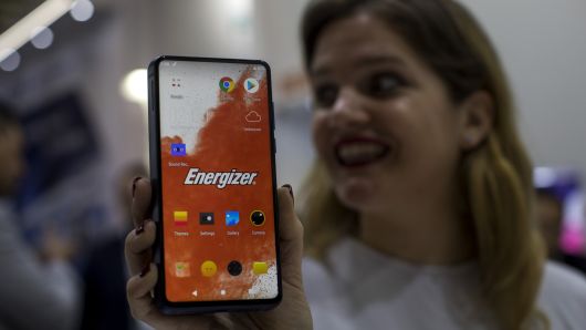 A worker holds a new model of P18K POP Energizer phone, with 18,000mAh battery, at the Mobile World Congress wireless show, in Barcelona, Spain, Tuesday, Feb. 26, 2019.