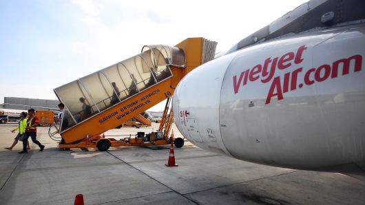 Passengers disembark a VietJet Air aircraft, operated by VietJet Aviation Joint Stock, at Tan Son Nhat International Airport in Ho Chi Minh City, Vietnam.