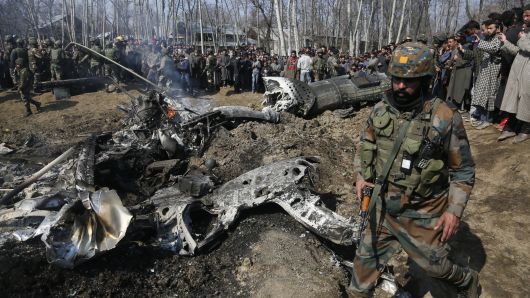 An Indian army solider walks past the wreckage of an Indian aircraft after it crashed in Budgam area, outskirts of Srinagar, Indian controlled Kashmir, Wednesday, Feb.27, 2019.
