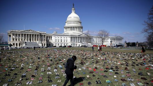 Seven thousand pairs of shoes, representing the children killed by gun violence since the mass shooting at Sandy Hook Elementary School in 2012, are spread out on the lawn on the east side of the U.S. Capitol March 13, 2018 in Washington, DC.