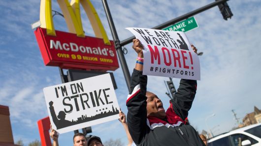 Demonstrators gather in front of a McDonald's restaurant to call for an increase in minimum wage on April 15, 2015 in Chicago, Illinois.