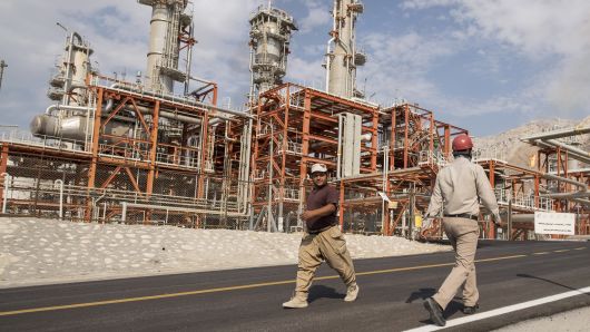 Iranian workers walk at a unit of South Pars Gas field in Asalouyeh Seaport, north of Persian Gulf, Iran November 19, 2015.