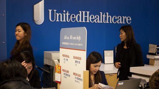 Representatives speak with customers at a UnitedHealthcare location in Queens, New York.