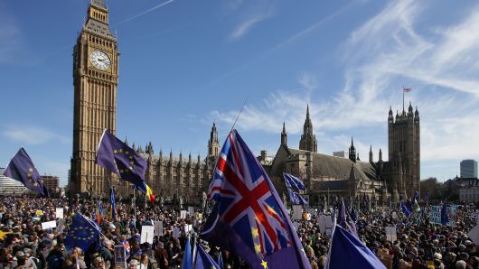 Demonstrators holding EU and Union flags gather in front of the Houses of Parliament in Parliament Square following an anti Brexit, pro-European Union march in London on March 25, 2017, ahead of the British government's planned triggering of Article 50.