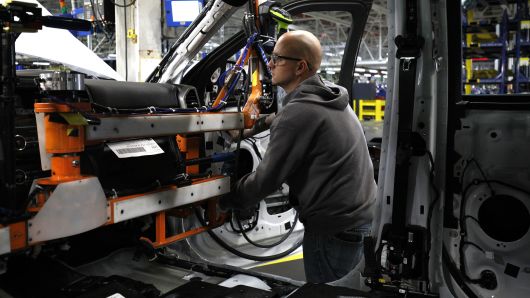 Workers build a truck as it goes through the assembly line at the Ford Kentucky Truck Plant in Louisville, Kentucky.