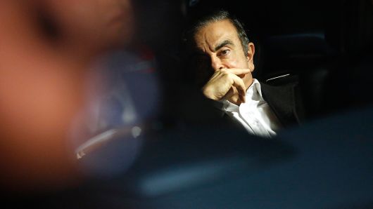 Carlos Ghosn, former chairman of Nissan Motor Co., center, sits in a taxi as he leaves his lawyer's office in Tokyo, Japan, on Wednesday, March 6, 2018.