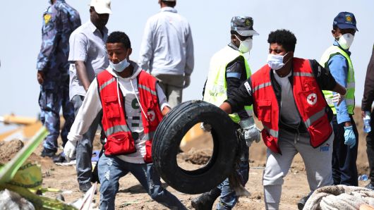 Search workers carry a tyre at the scene of the Ethiopian Airlines Flight ET 302 plane crash, near the town of Bishoftu, southeast of Addis Ababa, Ethiopia March 11, 2019.