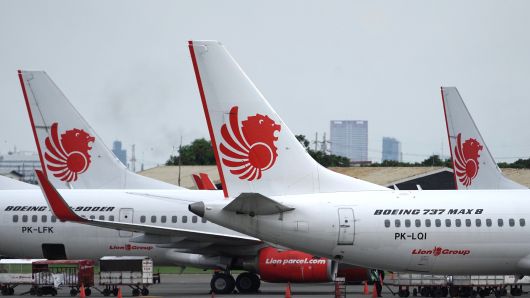 A Lion Air Boeing Co. 737 Max 8 aircraft, right, stands on the tarmac at Soekarno-Hatta International Airport in Cenkareng, Indonesia, on Tuesday, March 12, 2019.