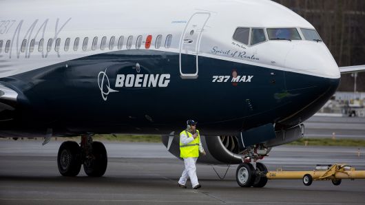 Crewman tow in a Boeing Co. Max 737 jet after landing at King County International Airport in Seattle, Washington, U.S., on Friday, Jan. 29, 2016. Boeing Co.'s newest 737 jetliner gunned its engines and headed into rain-streaked skies Friday, with profit and pride riding on its wings. Photographer: Mike Kane/Bloomberg via Getty Images