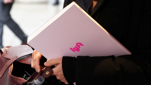 An investor walks out of the Lyft roadshow with documents in hand at a hotel in New York, New York, U.S., March 21, 2019.