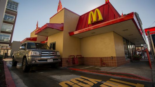 A customer waits for an order at the drive-thru of a McDonald's Corp. restaurant in San Pablo, California.