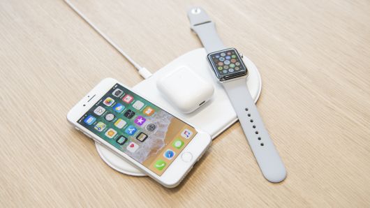 The Apple Inc. iPhone 8, Airpods, and Apple Watch sit on the AirPower charger during an event at the Steve Jobs Theater in Cupertino, California, U.S., on Tuesday, Sept. 12, 2017.