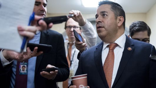 Rep. Ben Ray Lujan, D- N.M., speaks with reporters as he leaves the House Democrats' caucus meeting.